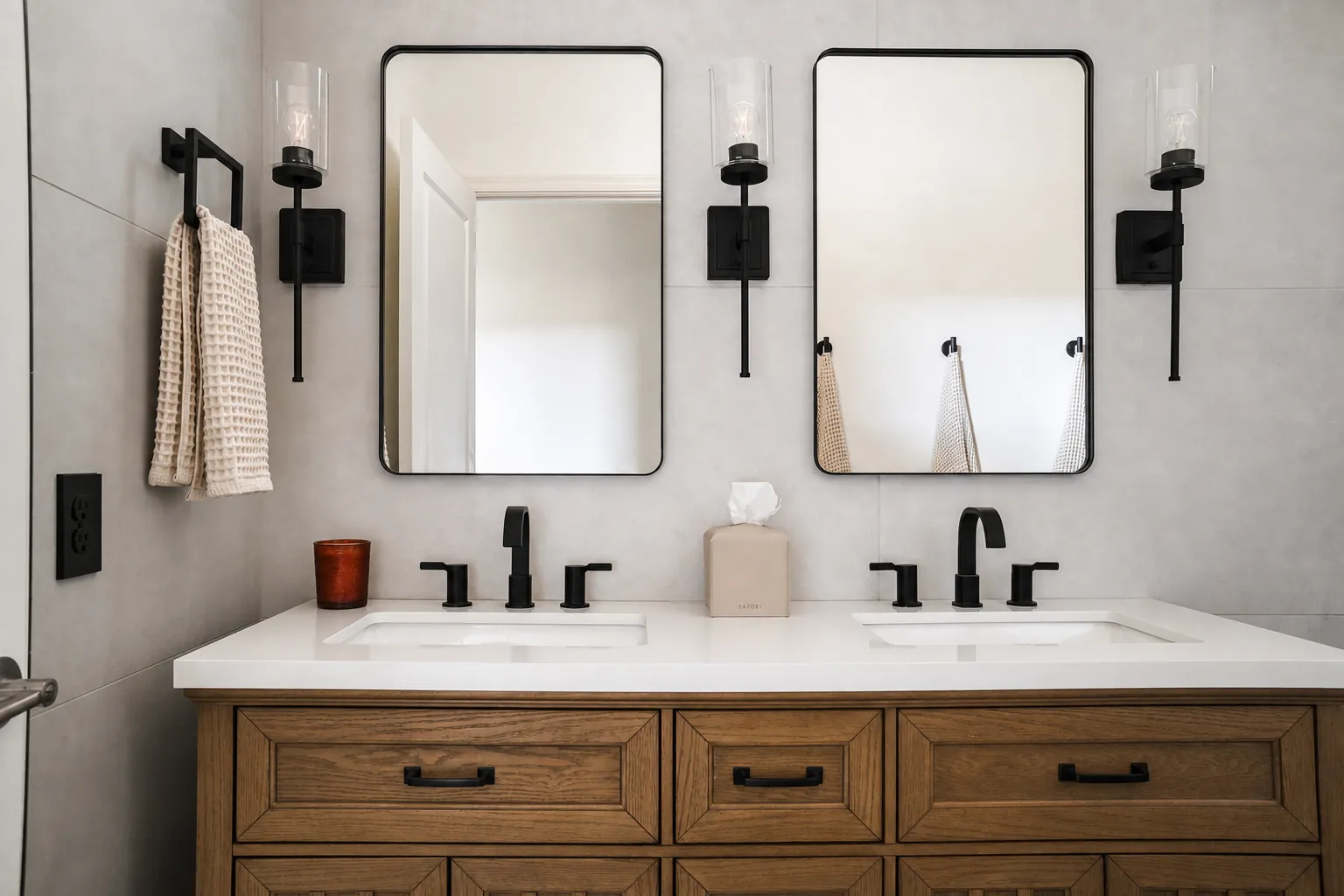 Remodeled double vanity with custom wood cabinetry and black fixtures